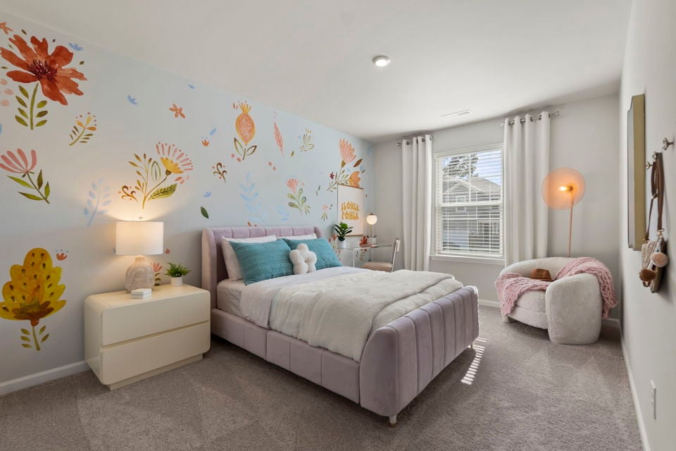 A bedroom with a bed and a couch.
