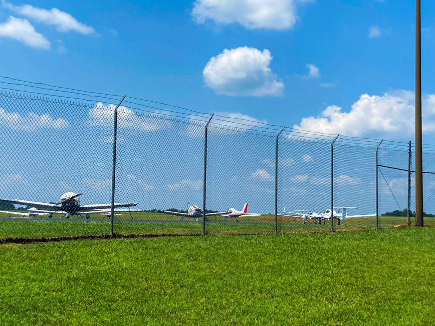 Airplanes parked in a field.