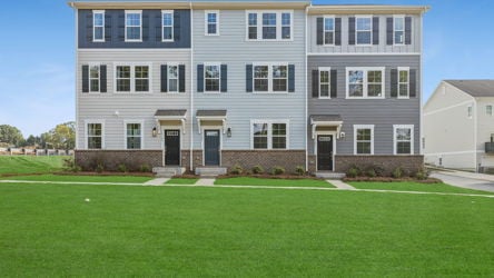 A large white building with a lawn in front of it.
