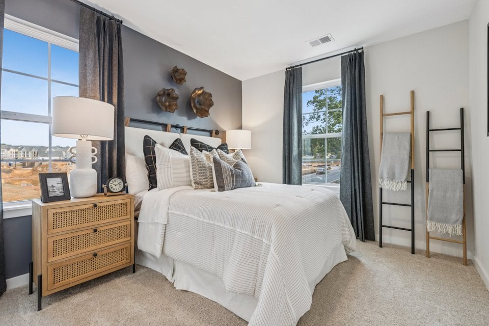 A bedroom with a bed and a window.