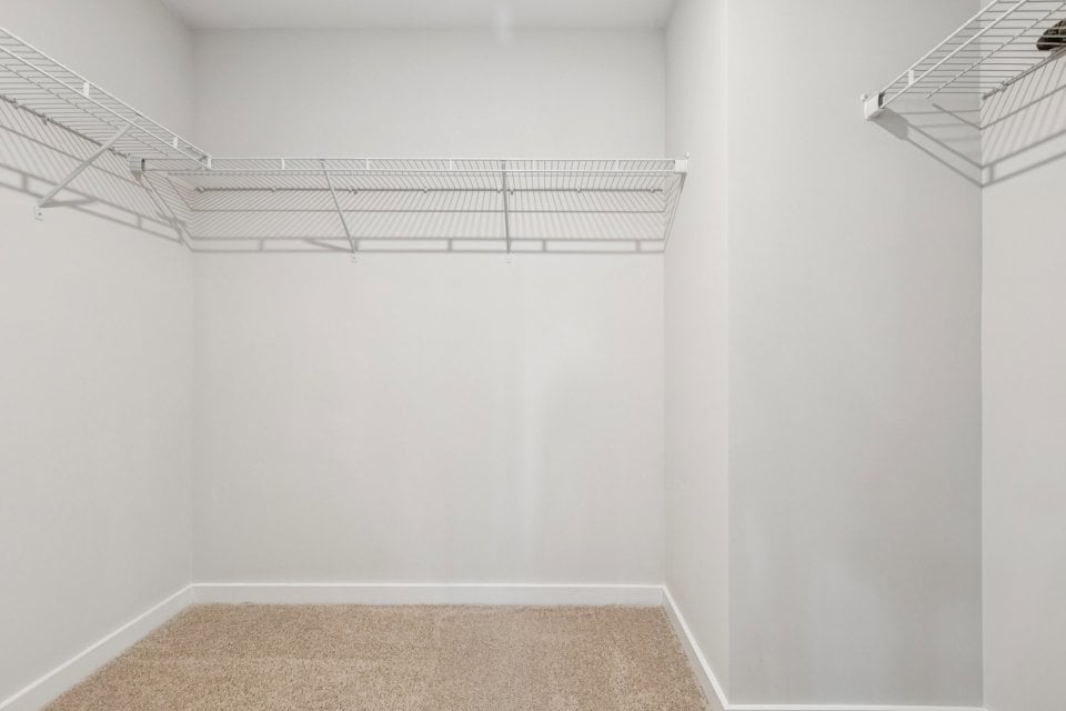 A white room with a rug.