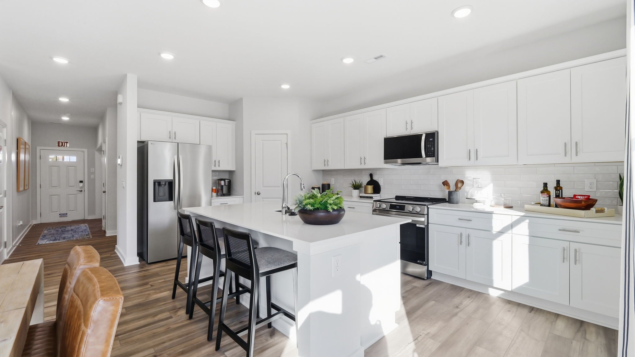 A kitchen with white cabinets.