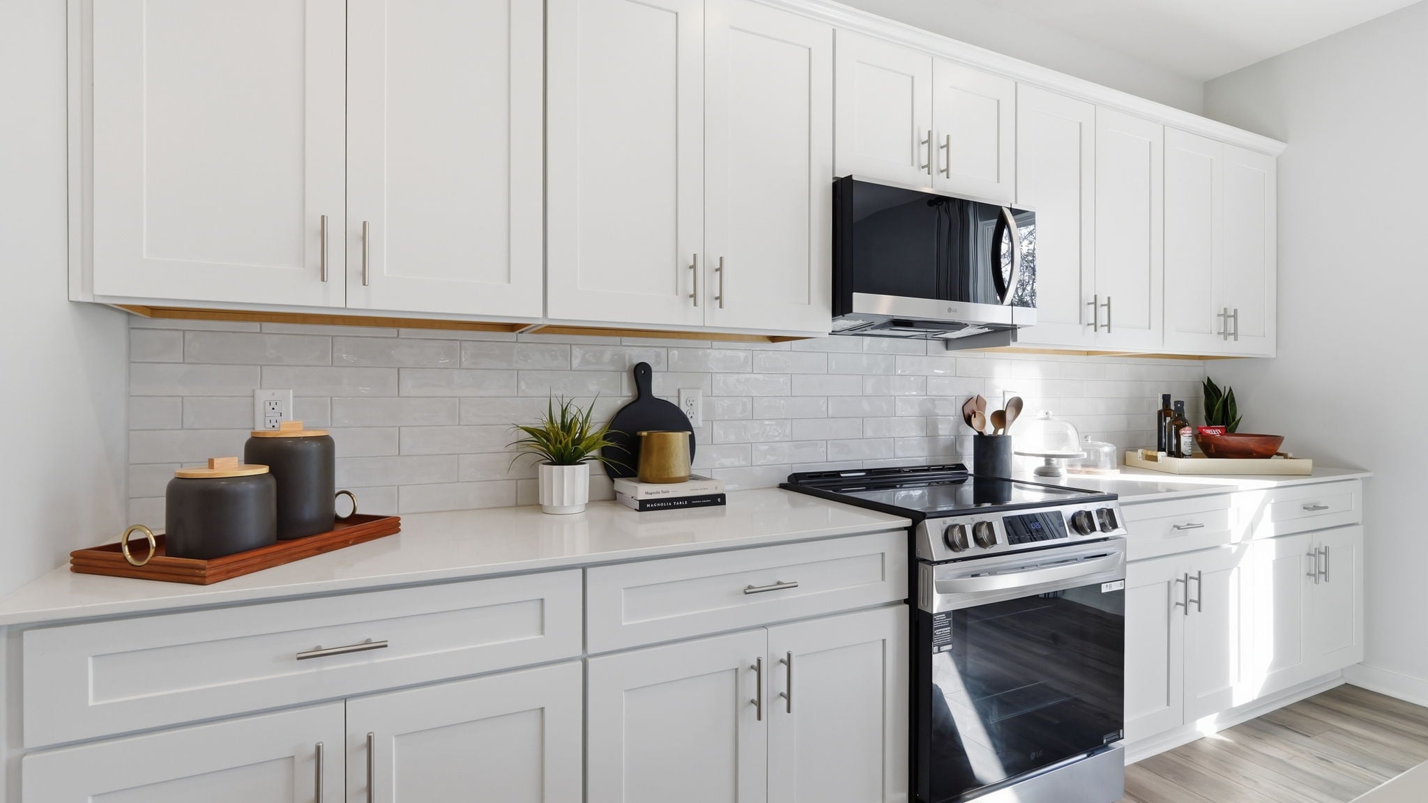 A kitchen with white cabinets.