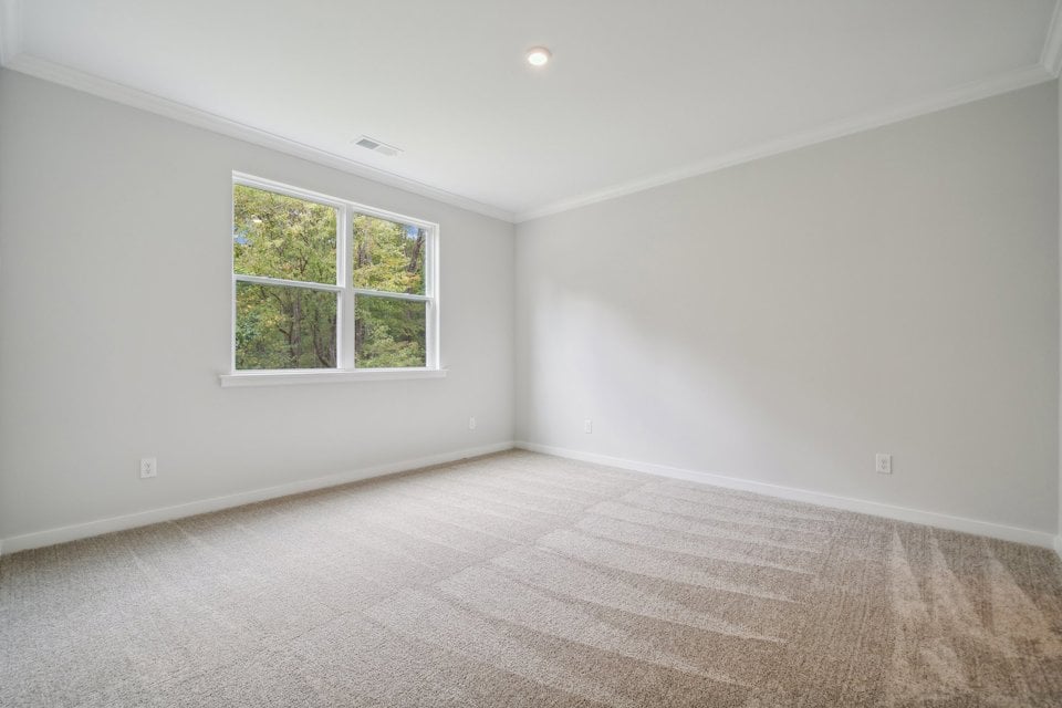 A room with a window and a carpet.