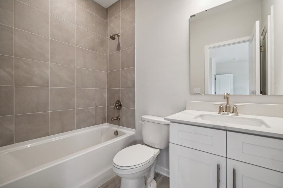A bathroom with a tub sink and toilet.