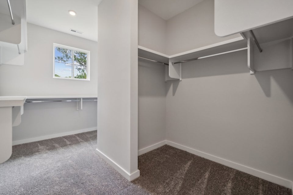 A room with a window and a white wall.