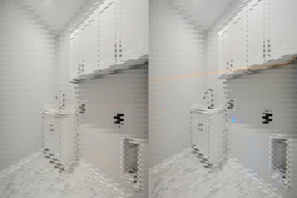 A white kitchen with white cabinets.