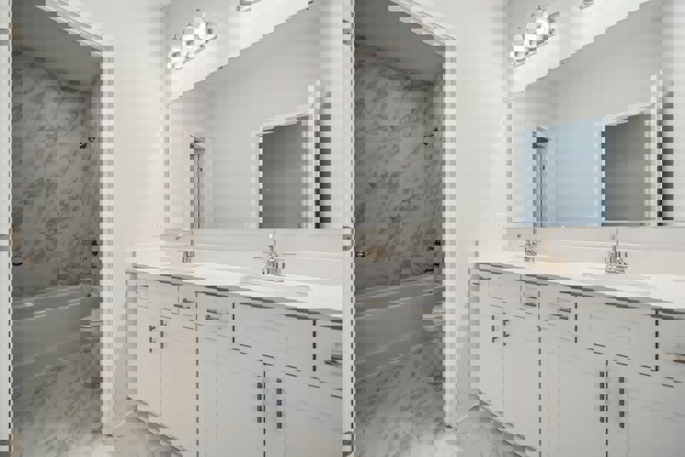 A bathroom with a tub sink and toilet.