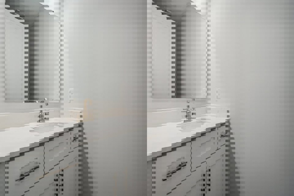 A bathroom with a sink and mirror.