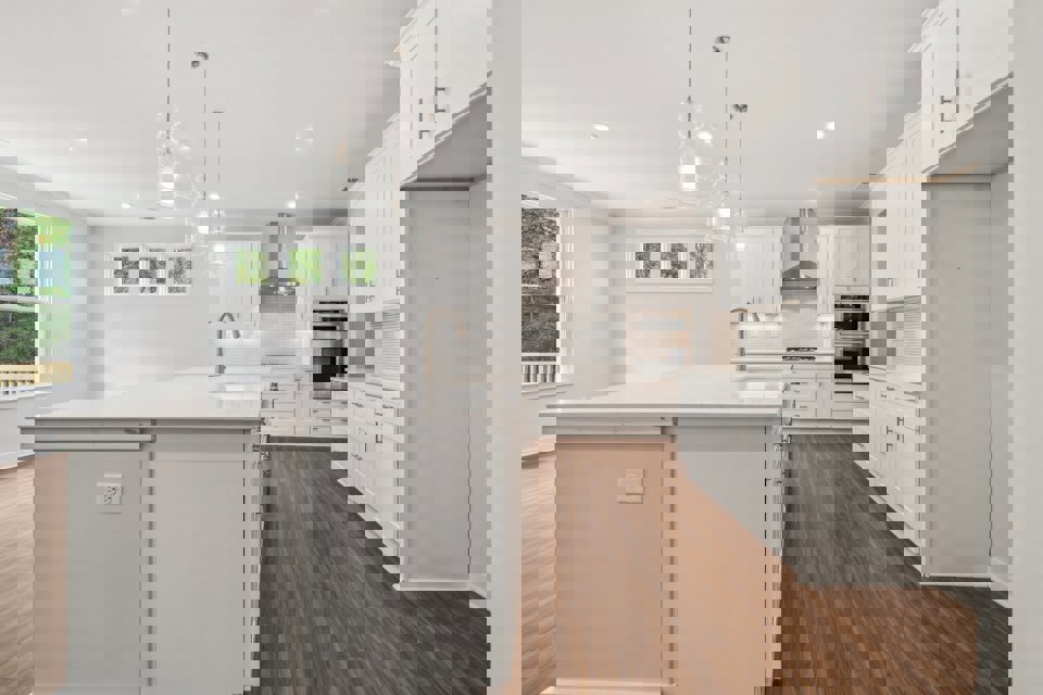 A kitchen with white cabinets.