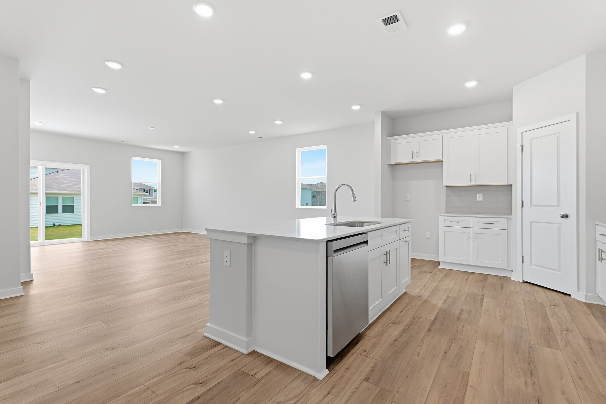 A kitchen with white cabinets.