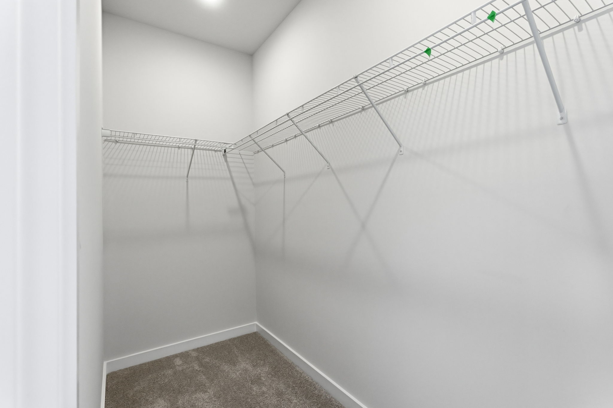 A white staircase with a metal railing.