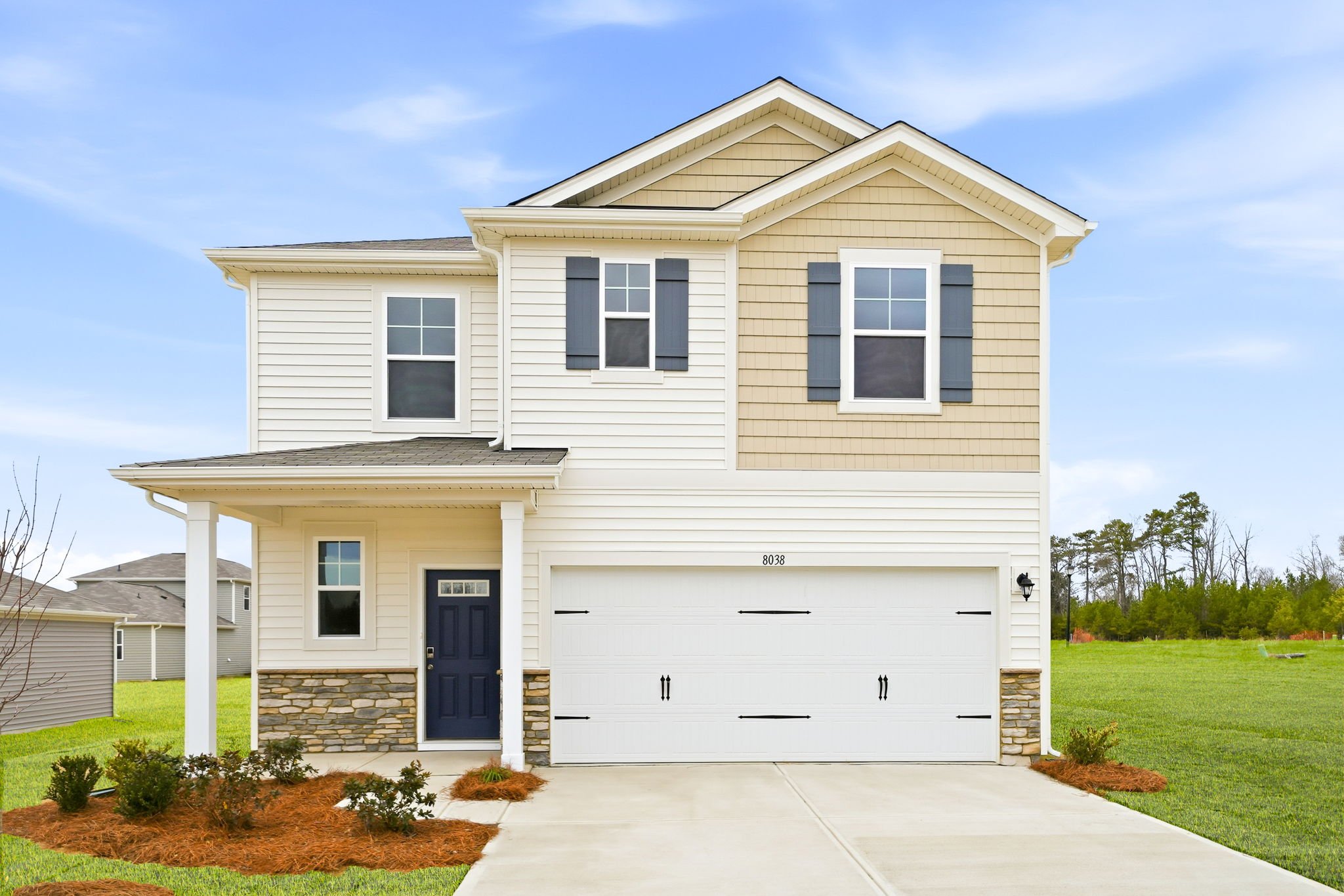 A white house with a driveway.
