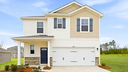 A white house with a driveway.