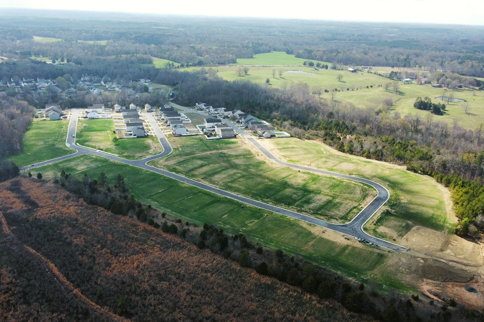 A landscape with a road and houses.