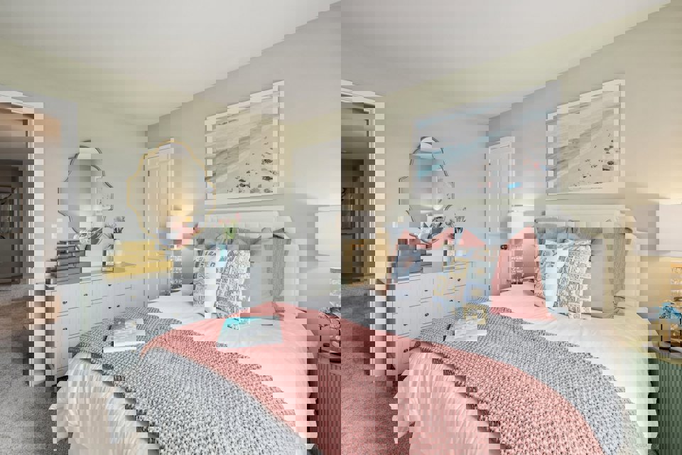 A bedroom with a bed and a mirror.