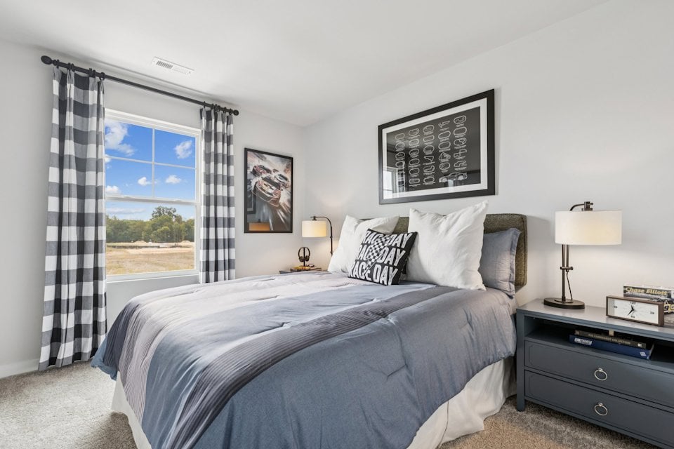 A bedroom with a large window.