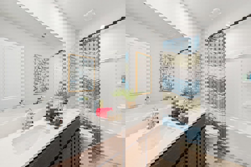 A bathroom with a tub sink and toilet.