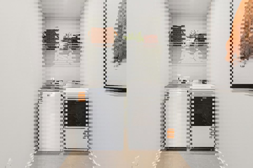 A washing machine and dryer in a room.