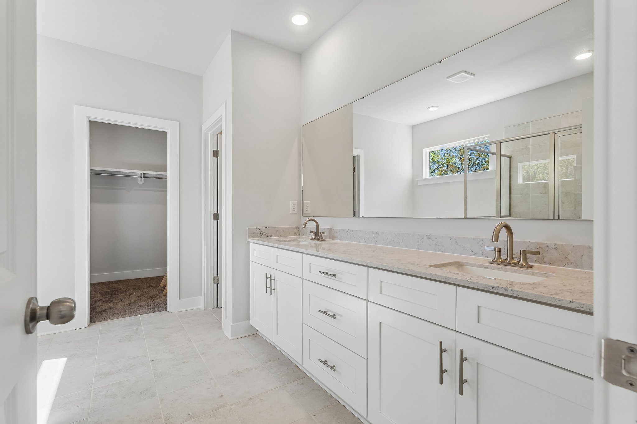 A bathroom with a large mirror.