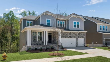 A large house with a tree in the front.