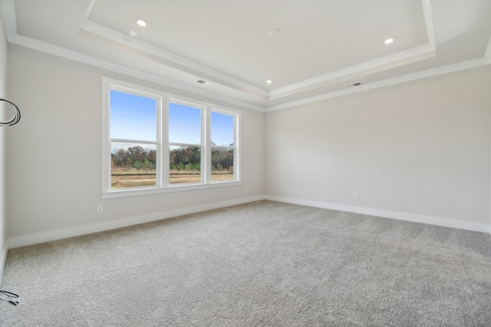 A room with a window and a carpet.
