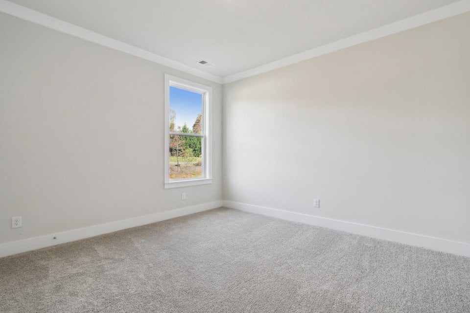 A room with a window and a carpet.