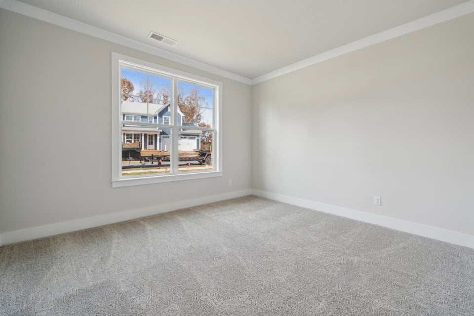 A room with a window and a carpet.