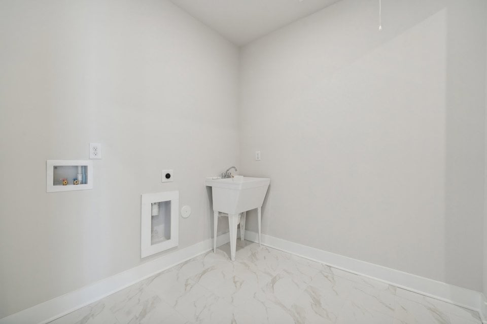 A white bathroom with a sink.