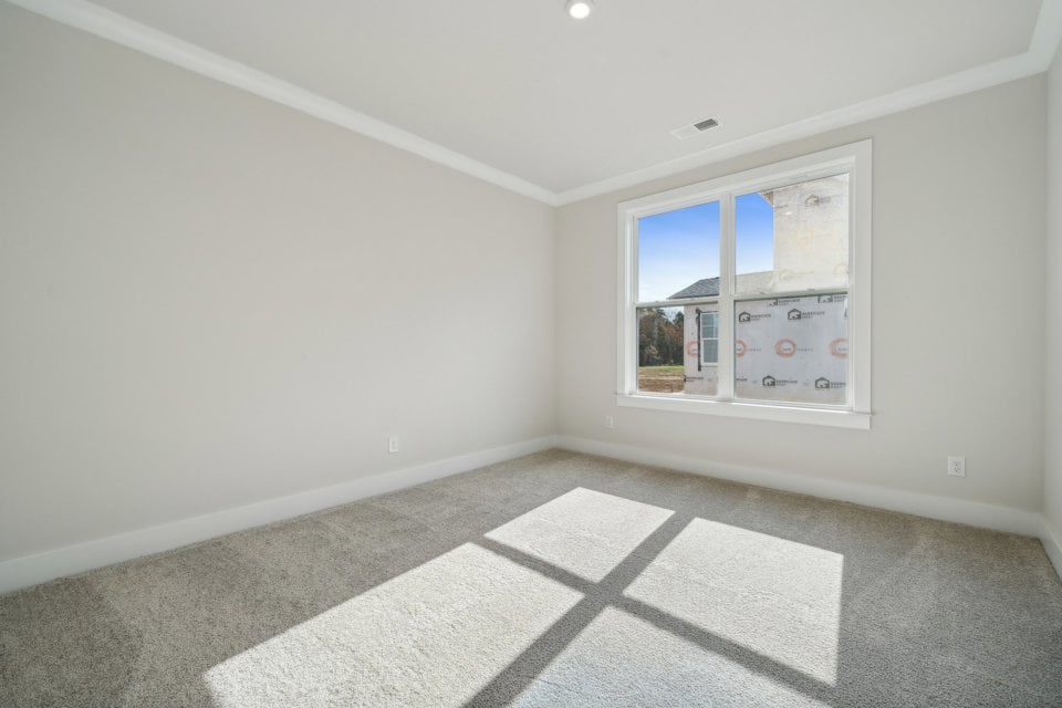 A room with a window and a tile floor.