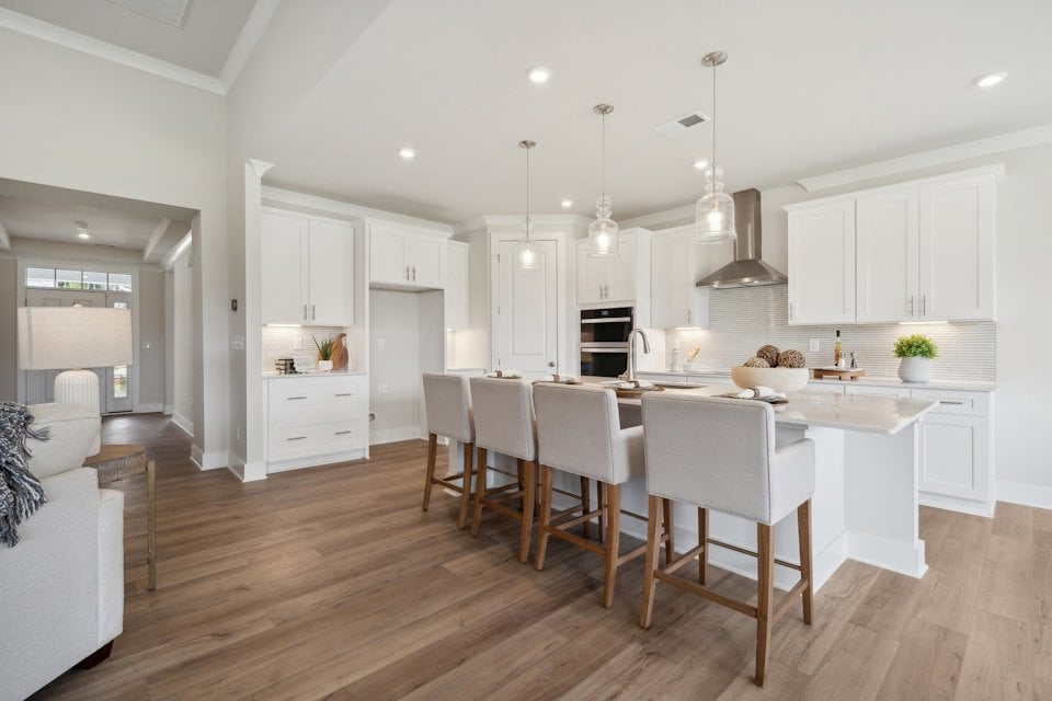 A kitchen with white cabinets.