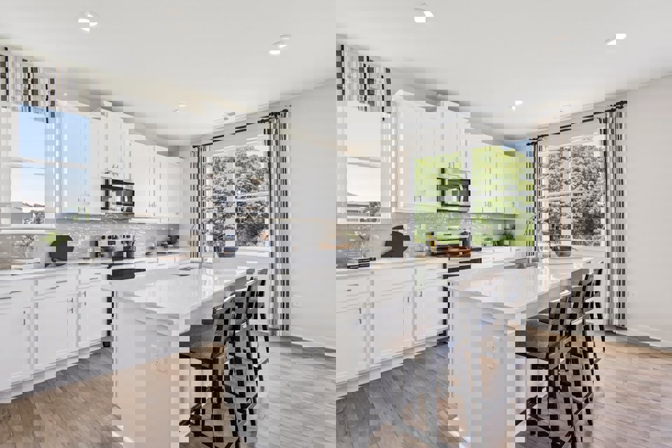 A kitchen with white cabinets.