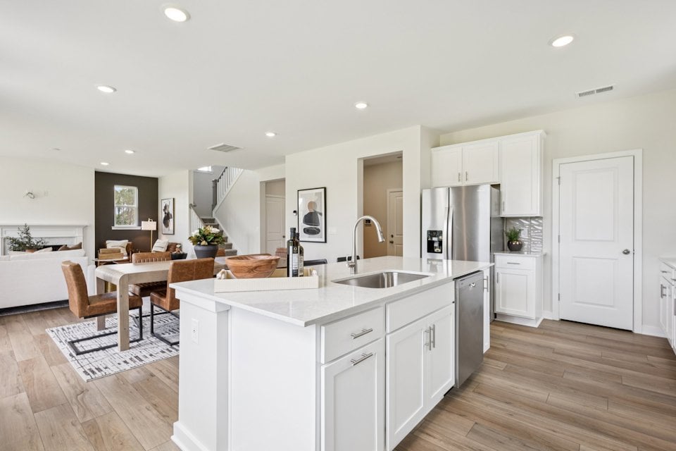 A kitchen with white cabinets.
