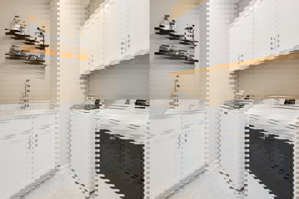 A kitchen with white cabinets.