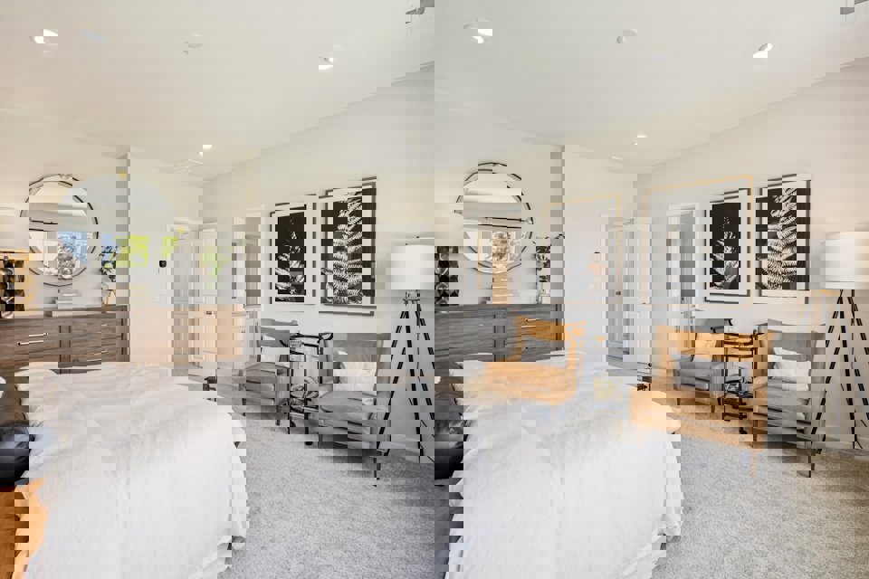 A bedroom with a bed and a chair.