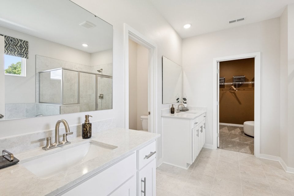 A bathroom with a large mirror.
