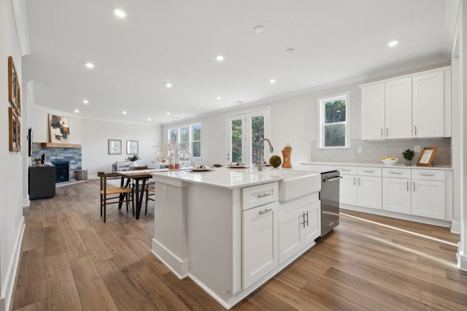 A kitchen with white cabinets.