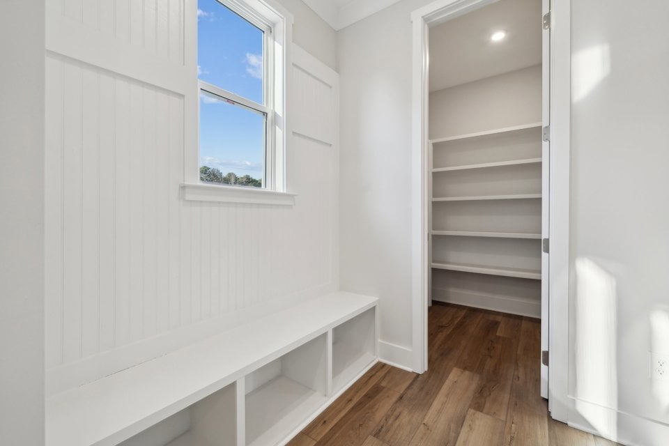 A room with white walls and a window.