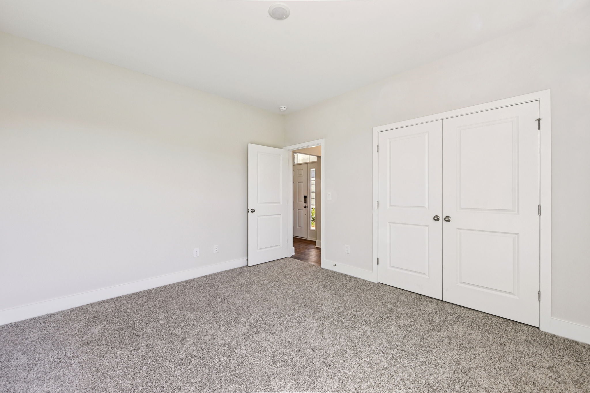 A hallway with white doors.