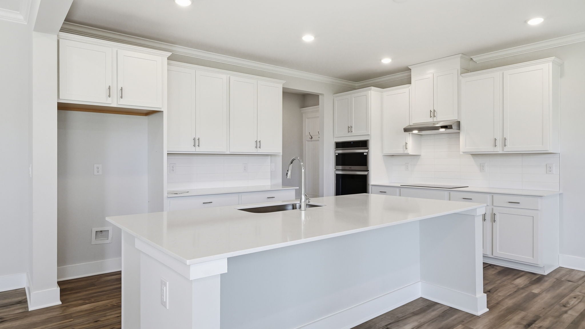 A kitchen with white cabinets.