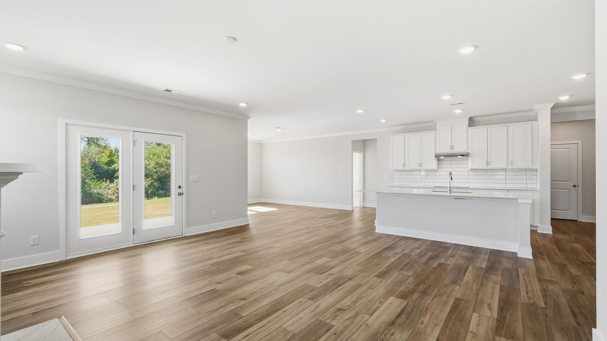 A large white kitchen with white cabinets.