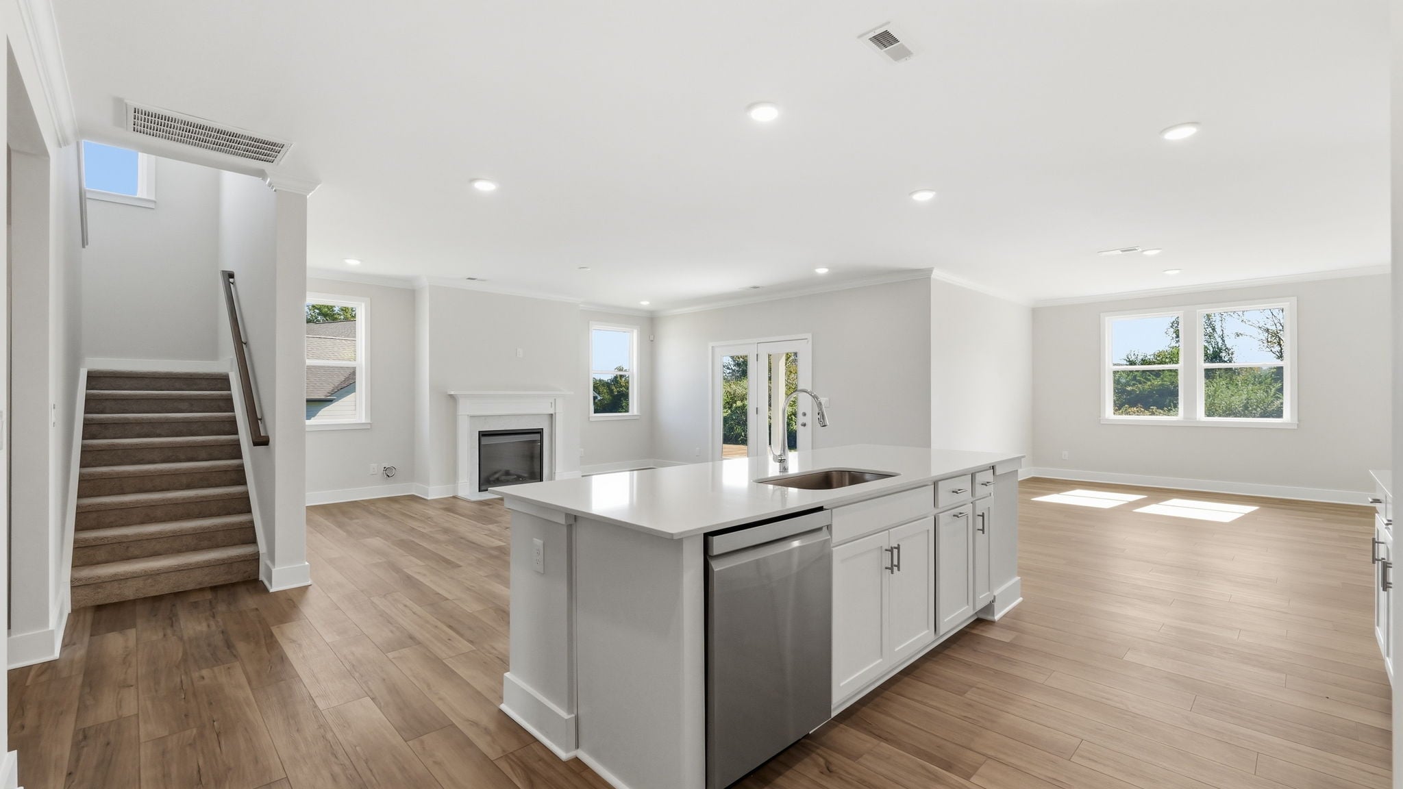 A kitchen with a wood floor.