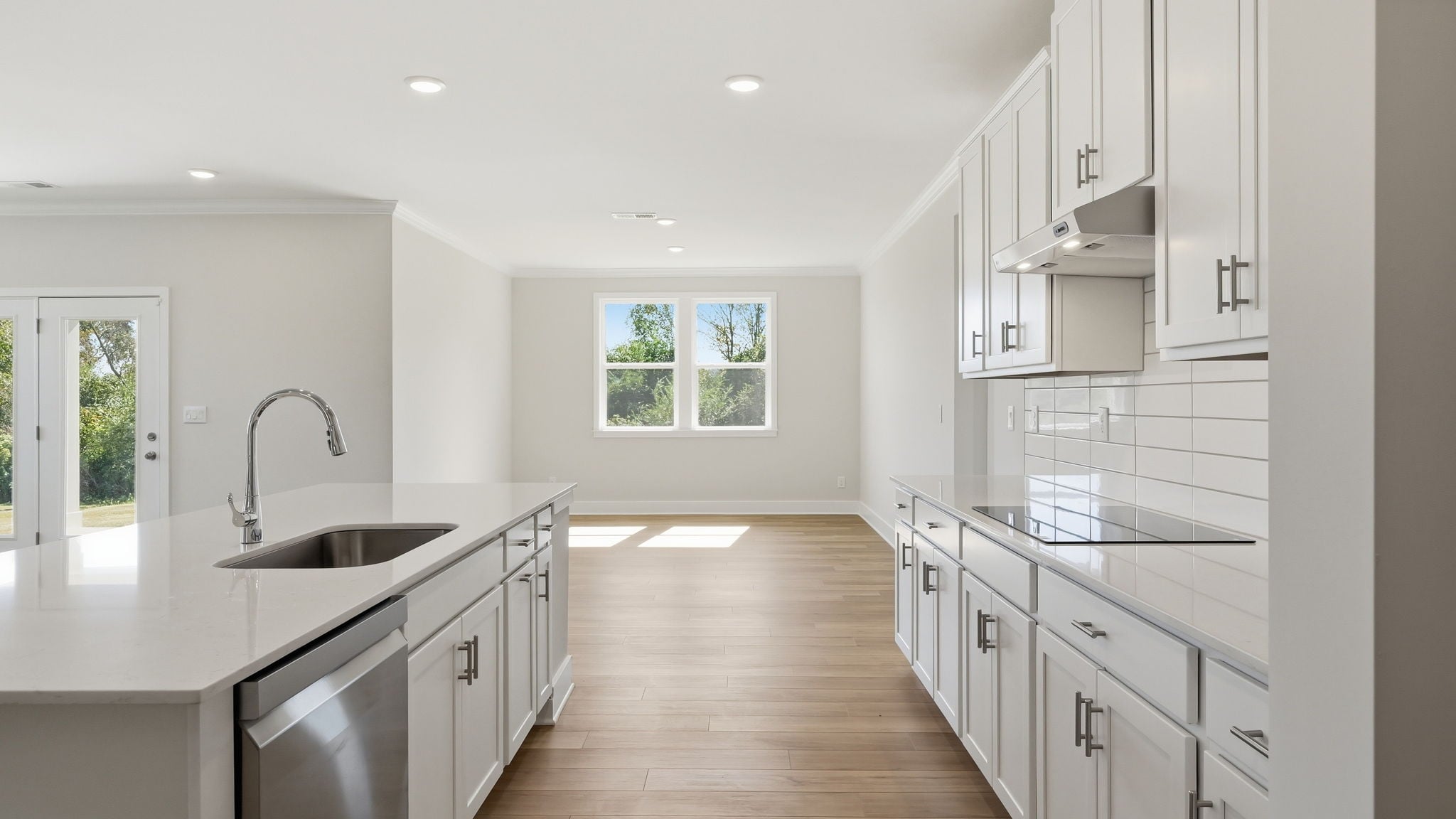 A kitchen with white cabinets.