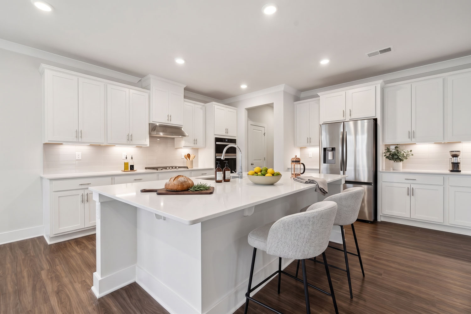 A kitchen with white cabinets.