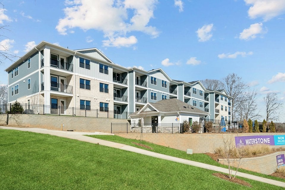 A large white building with a lawn in front of it.