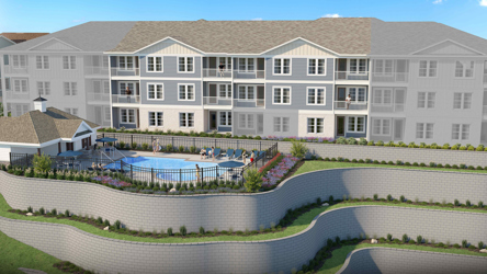 A large white building with a pool.