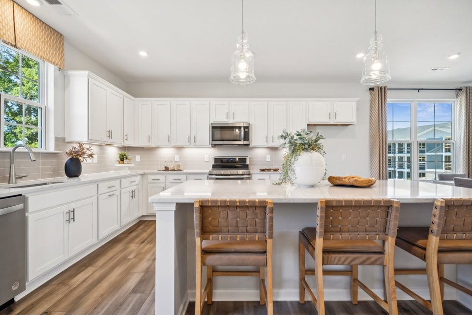 A kitchen with a table and chairs.