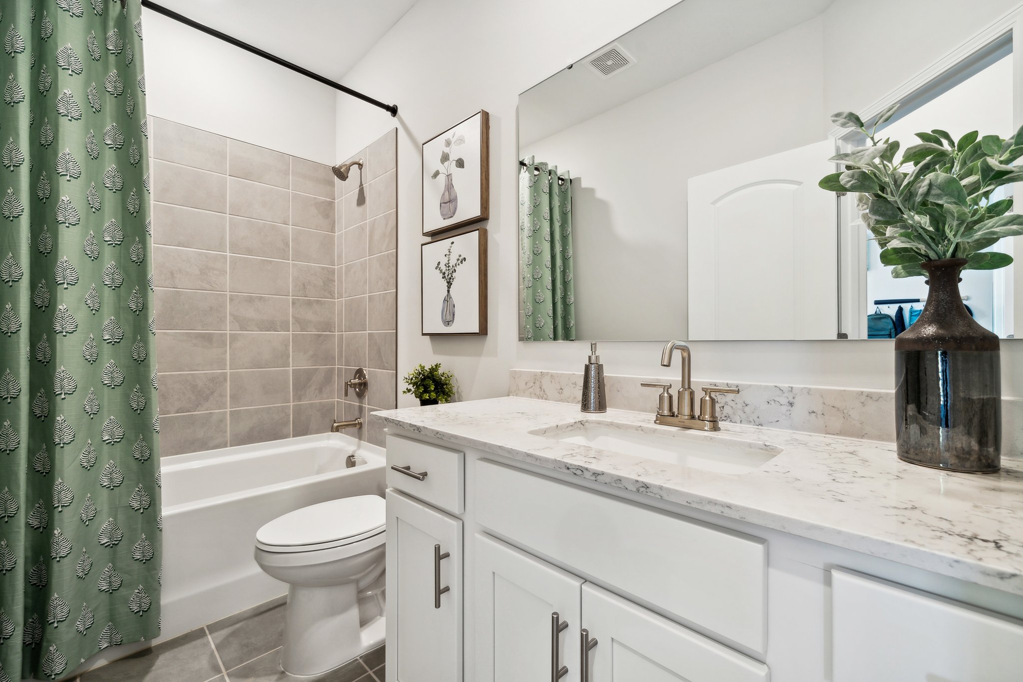 A bathroom with a sink toilet and a bathtub.