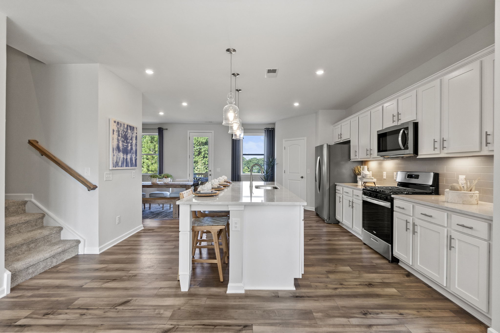 A kitchen with white cabinets.