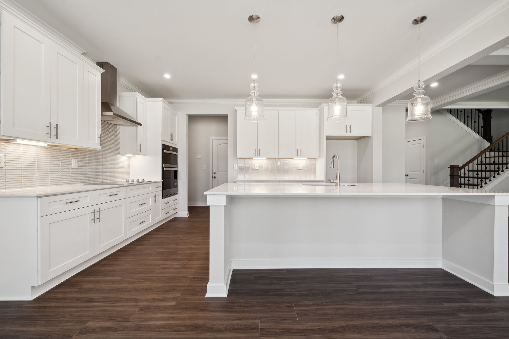 A kitchen with white cabinets.